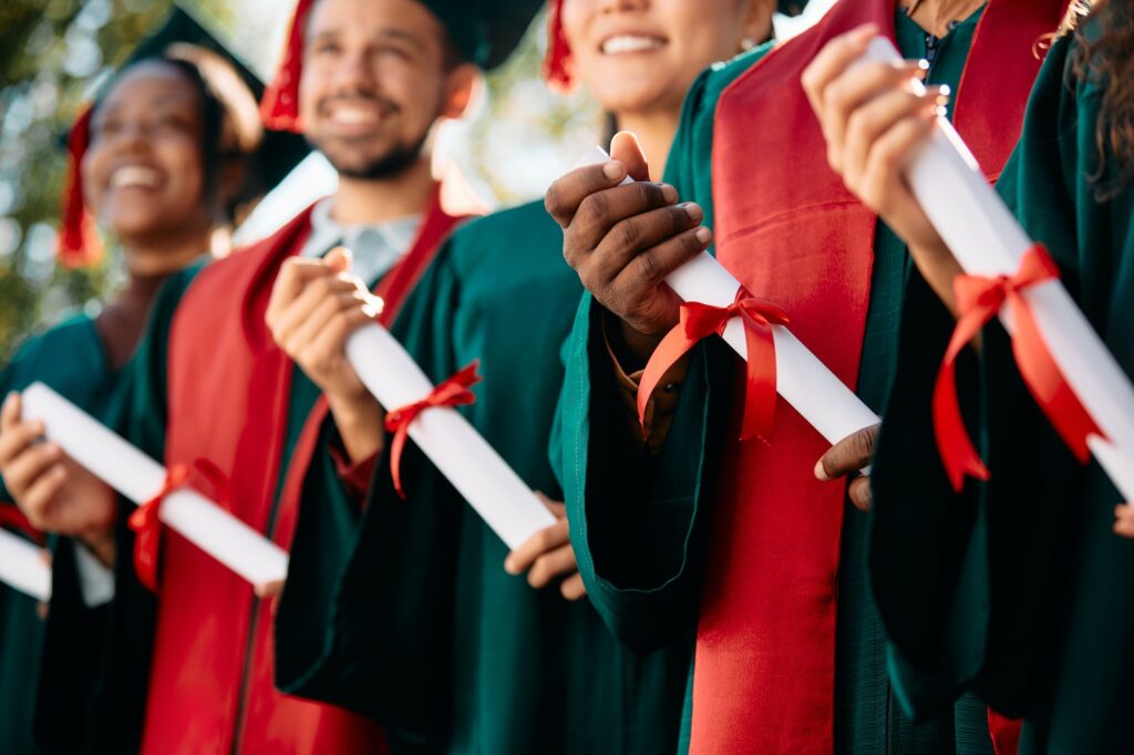 Close-up of students with graduation certificates.